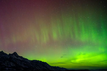 Aurora Borealis over Rugged Landscape